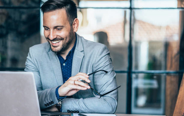 Young cheerful businessman working at office